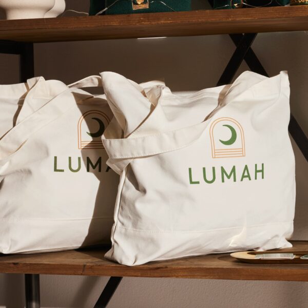 Green logo printed on a beige tote bag