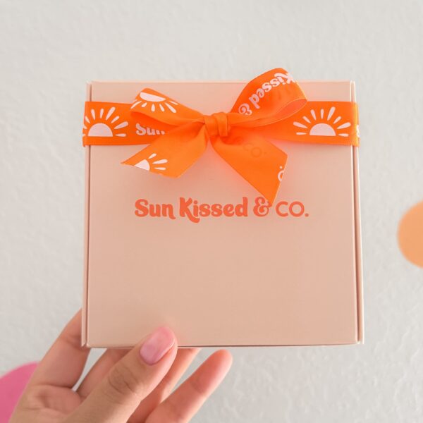 Orange logo on a ribbon mailer box