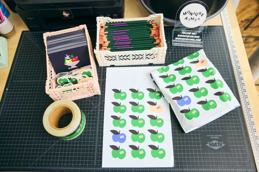 Colorful packaging materials, stickers, and stationery on a worktable, showing simple creative projects ideal for graphic design for beginners.