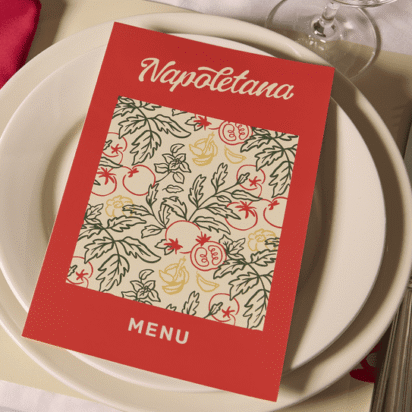 Bi-fold menu placed on plates at a restaurant