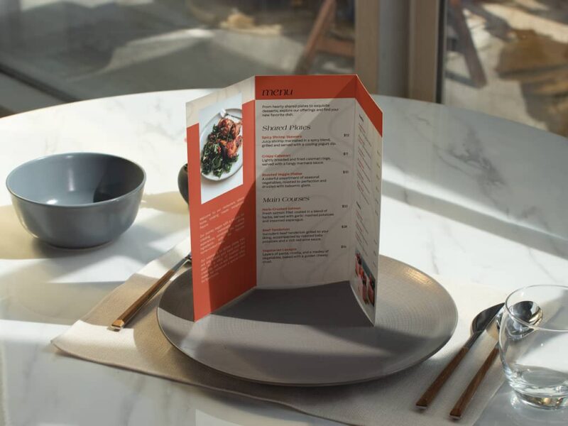 Tri-fold restaurant menu standing on a plate