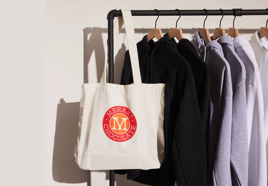 A selection of corporate gift items, including totes and clothing