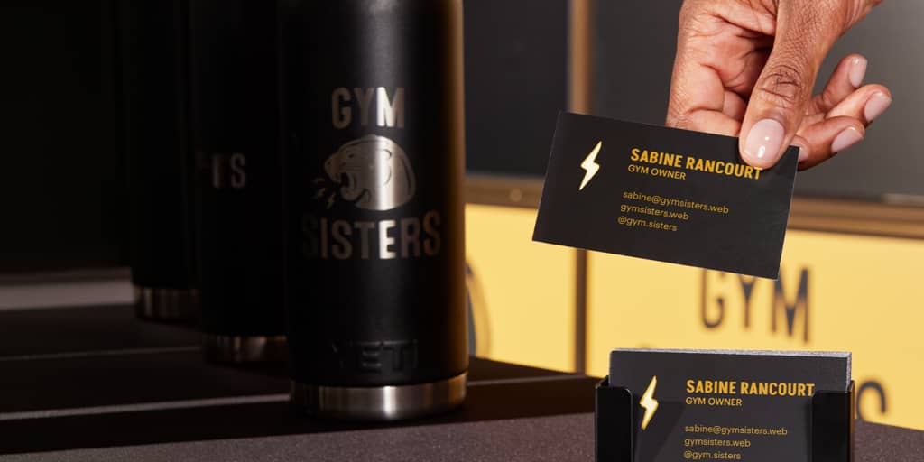 Yellow and black business card design for a gym using brand colors and shapes, elements of a brand