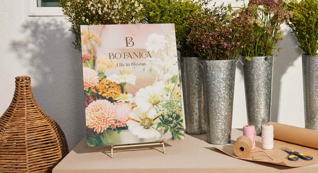 Promotional signage for a florist with brand name, logo and tagline