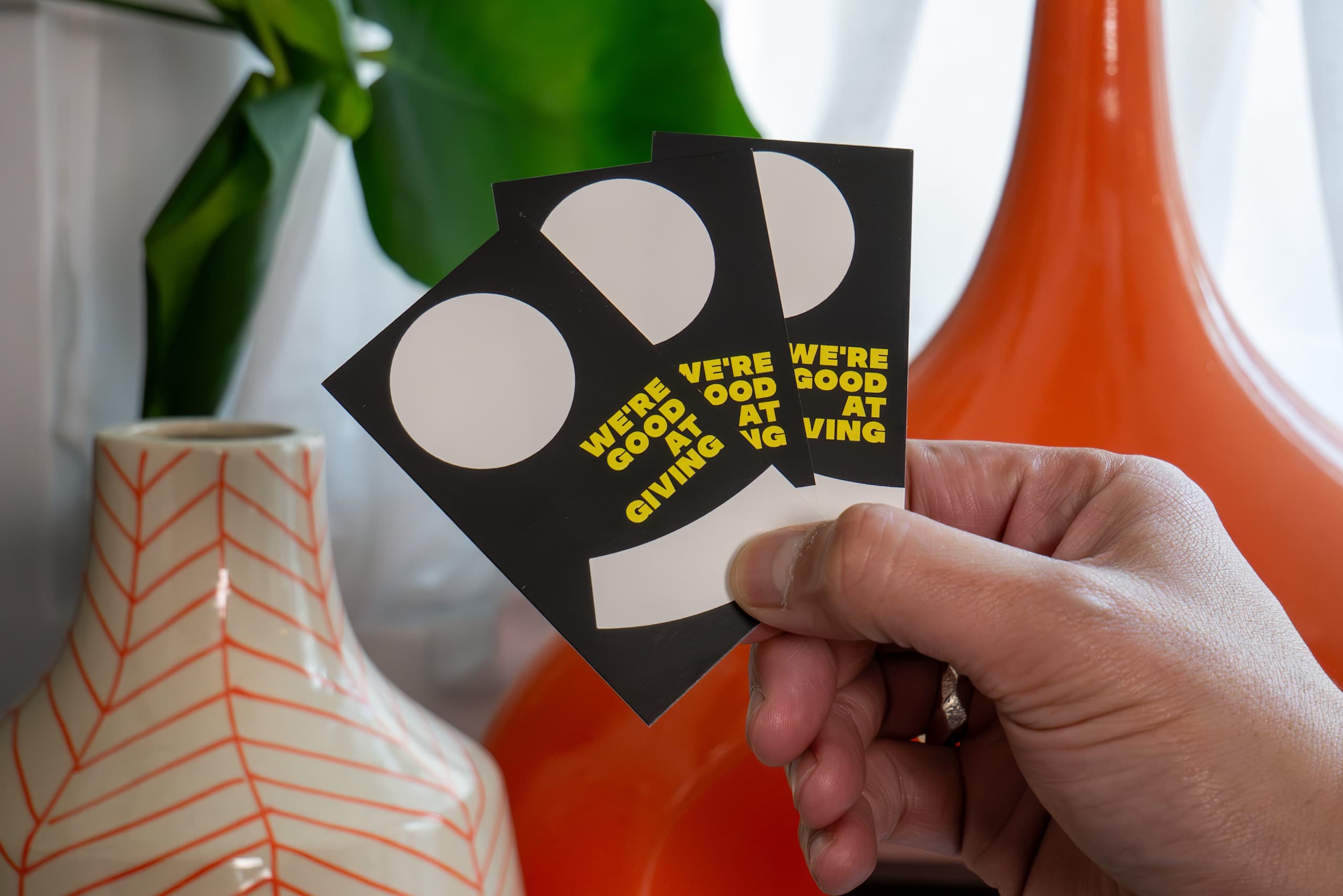 FRUITLOOTS business cards in brand colors and patterns, using the brand&rsquo;s tagline &ldquo;We&rsquo;re good at giving&rdquo;