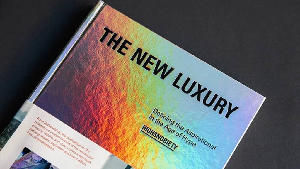 holographic book cover titled “The New Luxury” by Highsnobiety, example of brand voice in fashion and lifestyle publishing