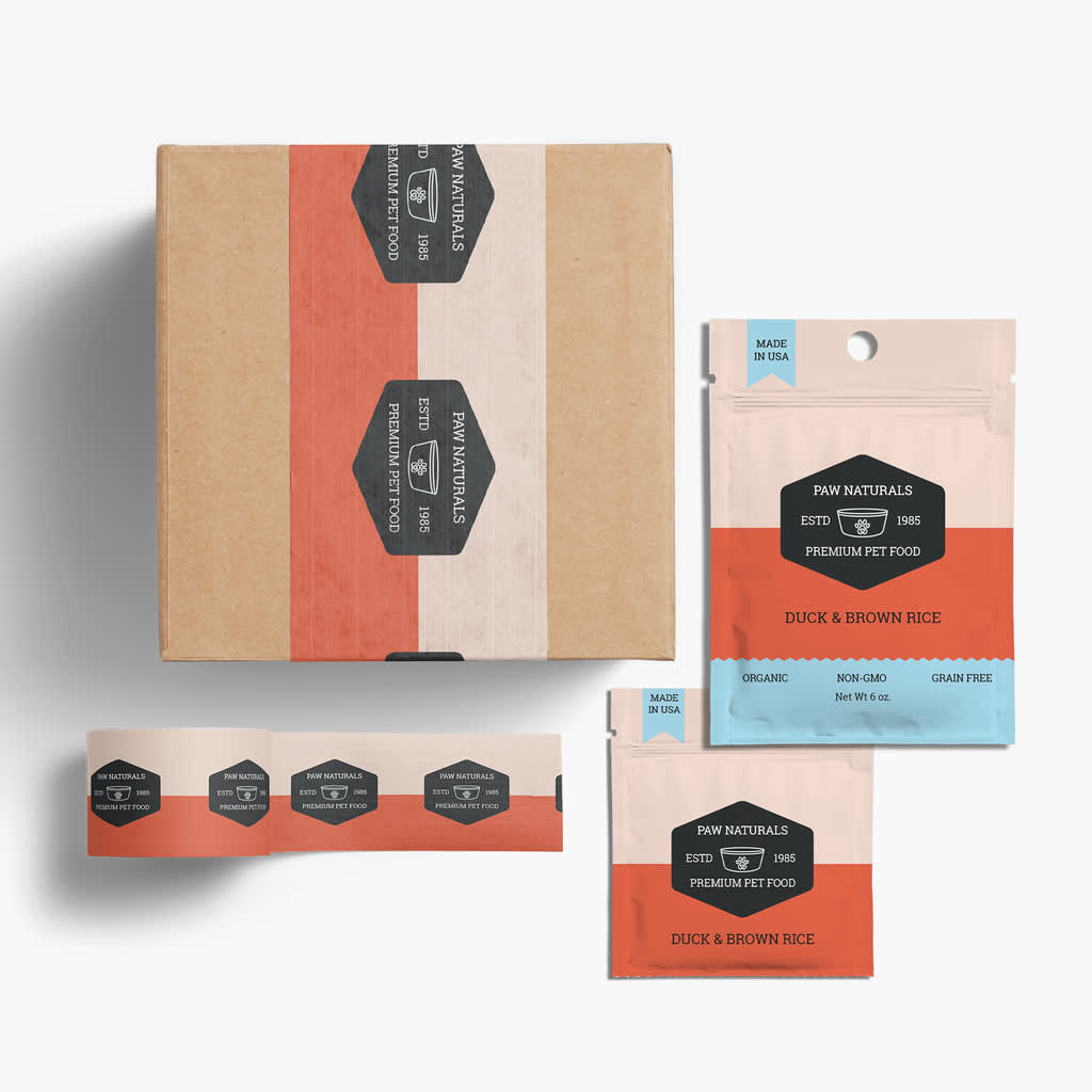 Branded box and matching pouch for minimalist pet food company lay on white background