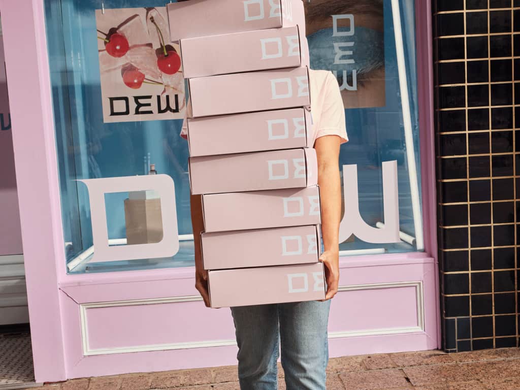 Pink brand color palette across packaging and storefront design