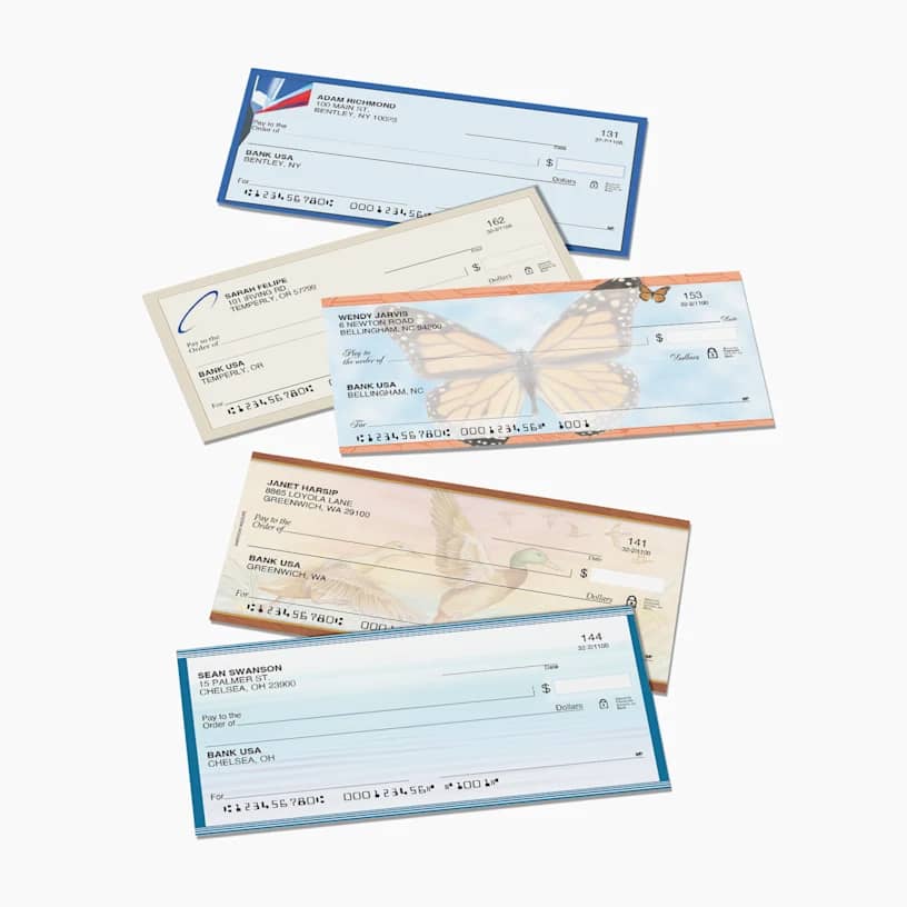 A range of custom business checks with logo and subtle duck and butterfly prints