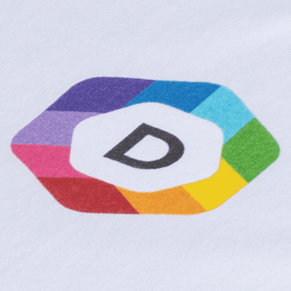 A close-up of a multi-colored brand logo printed on white fabric using the Direct-to-Garment (DTG) printing method