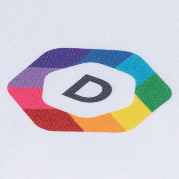 A close-up of a multi-colored brand logo printed on white fabric using the dye sublimation logo printing method