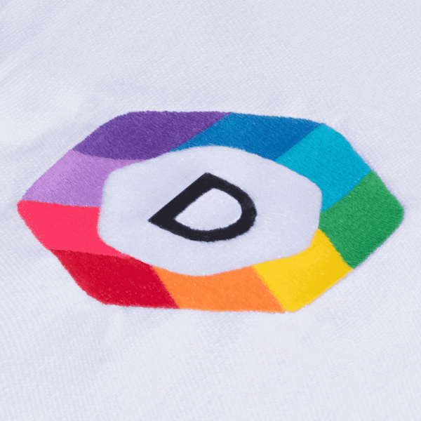 A close-up of a multicolored logo printed on white fabric via embroidery