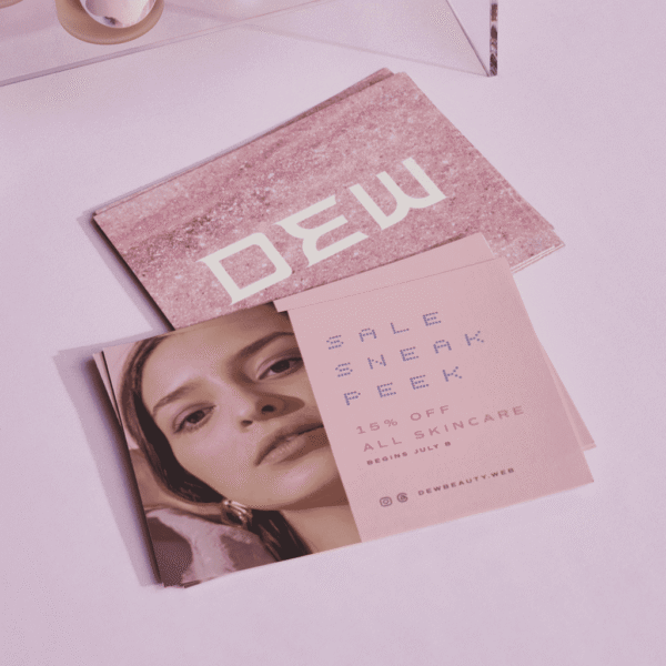 Pink branded postcard with the brand logo on a textured background on one side and the text &ldquo;Sale sneak peak&rdquo; on the other side]