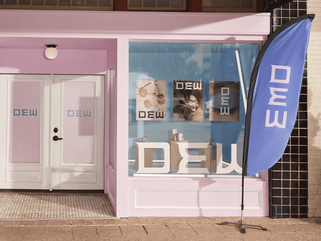 Retail brand storefront featuring different types of outdoor advertising, like flags and posters