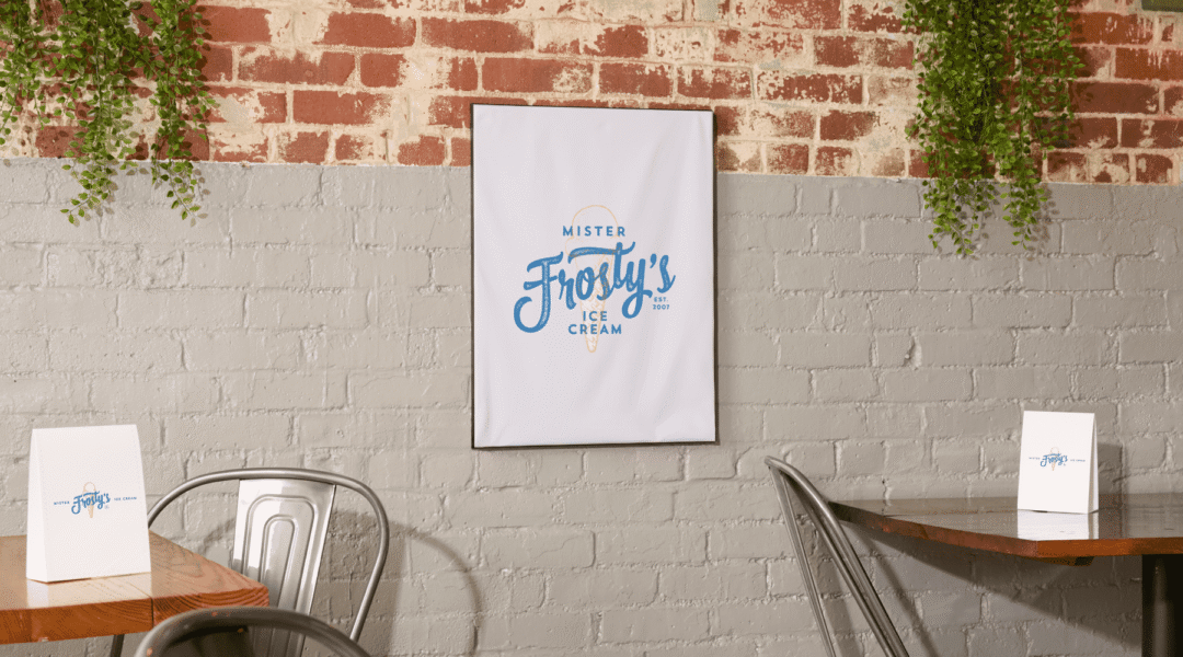 A white poster on a brick wall, advertising ice cream using the Pantone Color of the Year