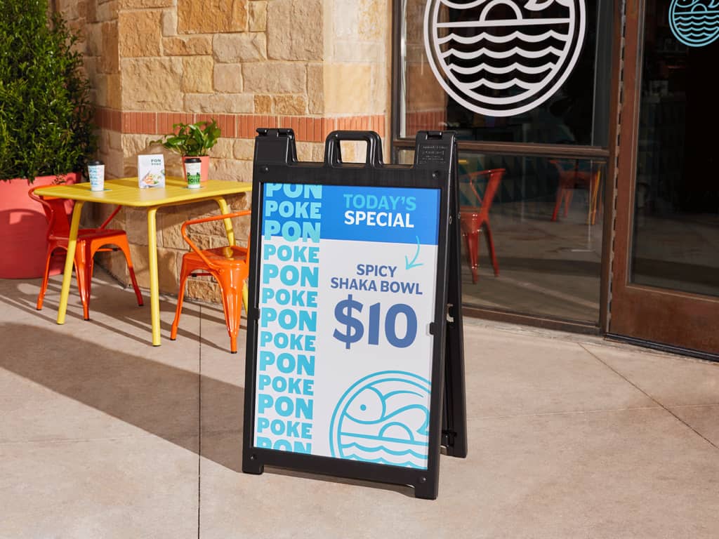 a pavement sign for a poke restaurant, outdoor advertising