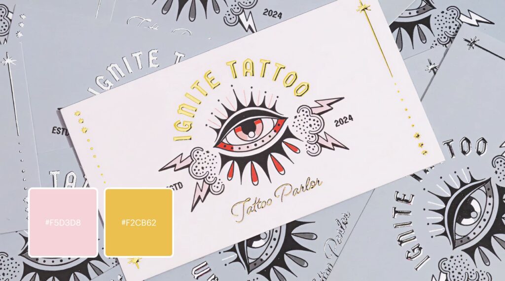 A bold, high contrast tattoo parlor logo features traditional line art, tempered by unexpected splashes of baby pink and gold foil.