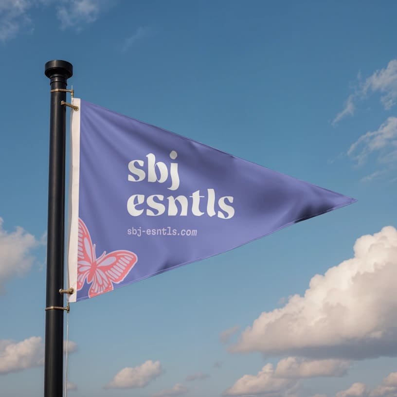 Branded pennant flag hanging from pole with sky as background