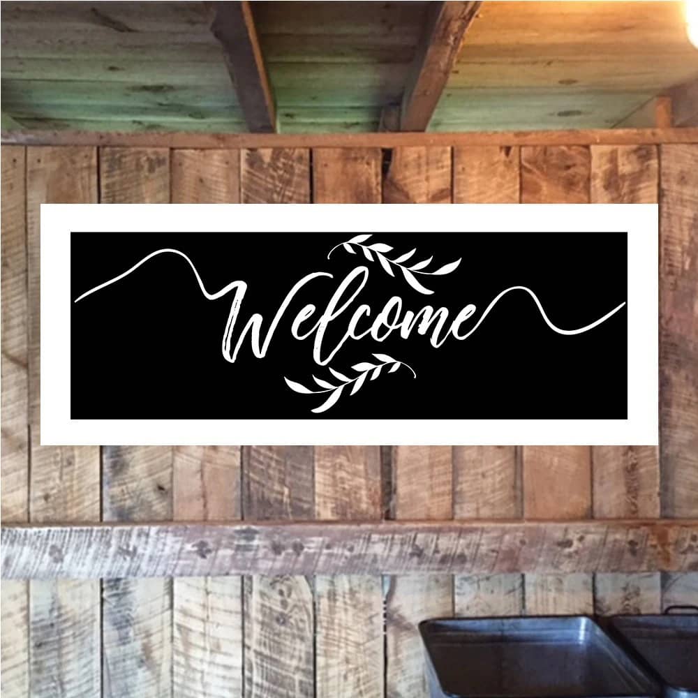 Chalkboard wedding sign with white calligraphy displaying welcome message