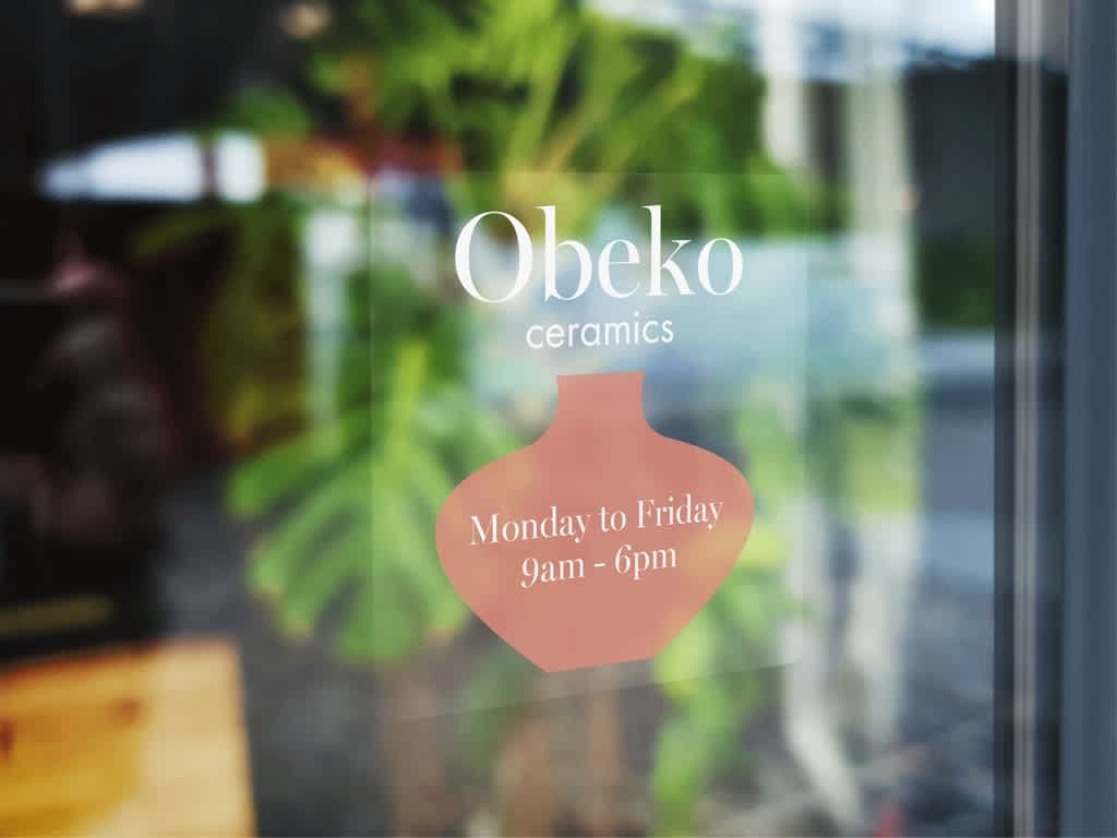 Custom window sticker with a ceramics store opening hours