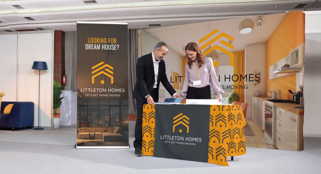 A housing company setting up a stall at a business conference event