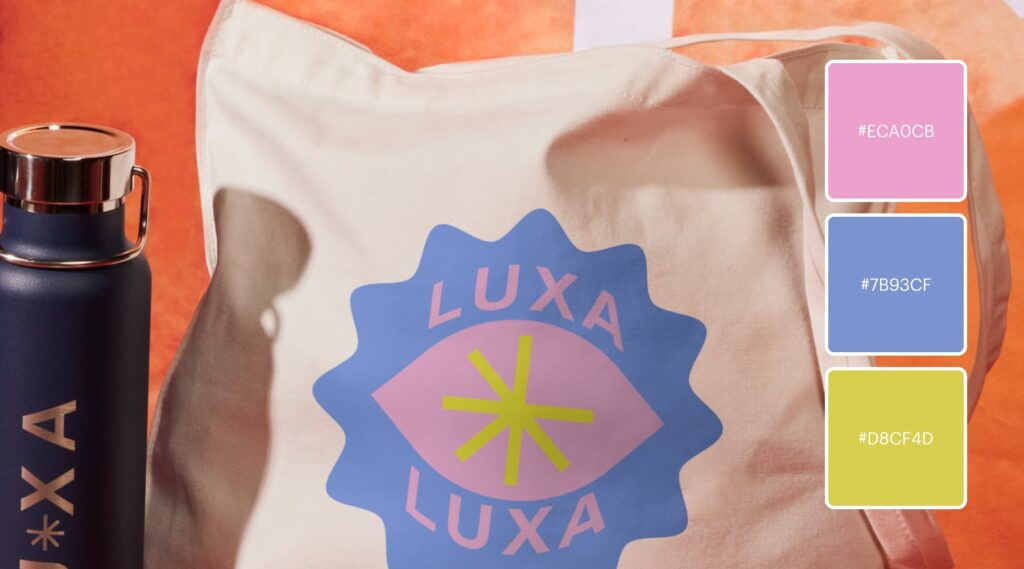 Branded tote bag features logo with a flower-like shape in low-contrast pink and purple with a bold green accent