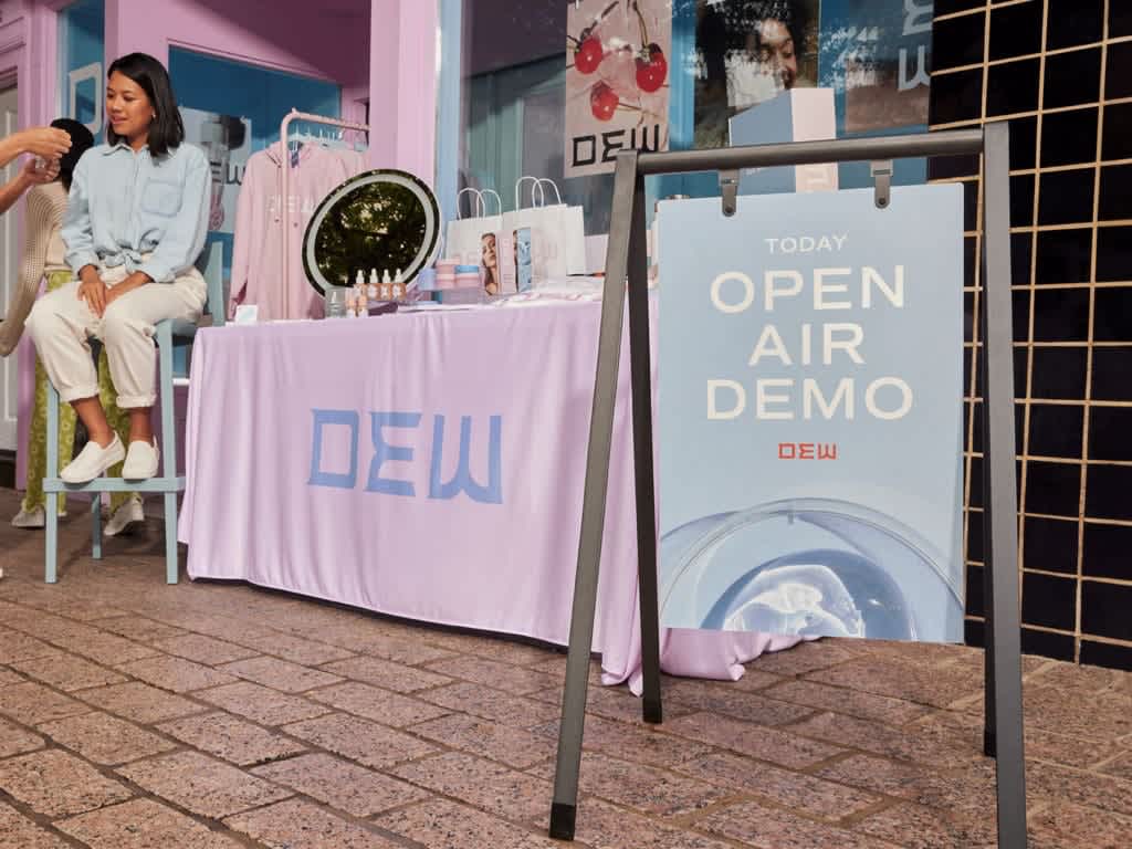 A-frame sign for a beauty business promoting an open air demo