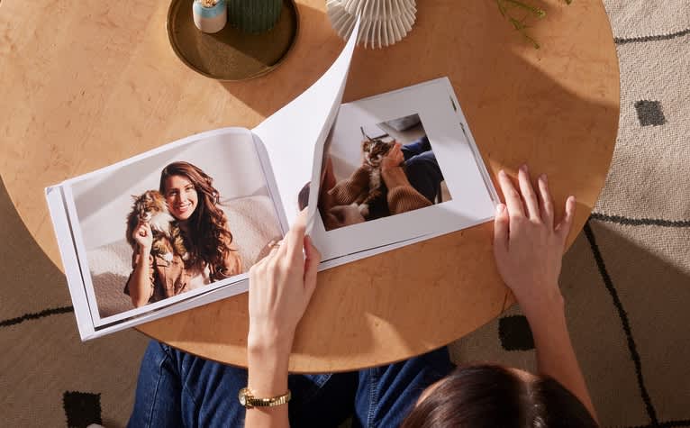 Photos of a woman and her pet cat in a personalized pet photo book