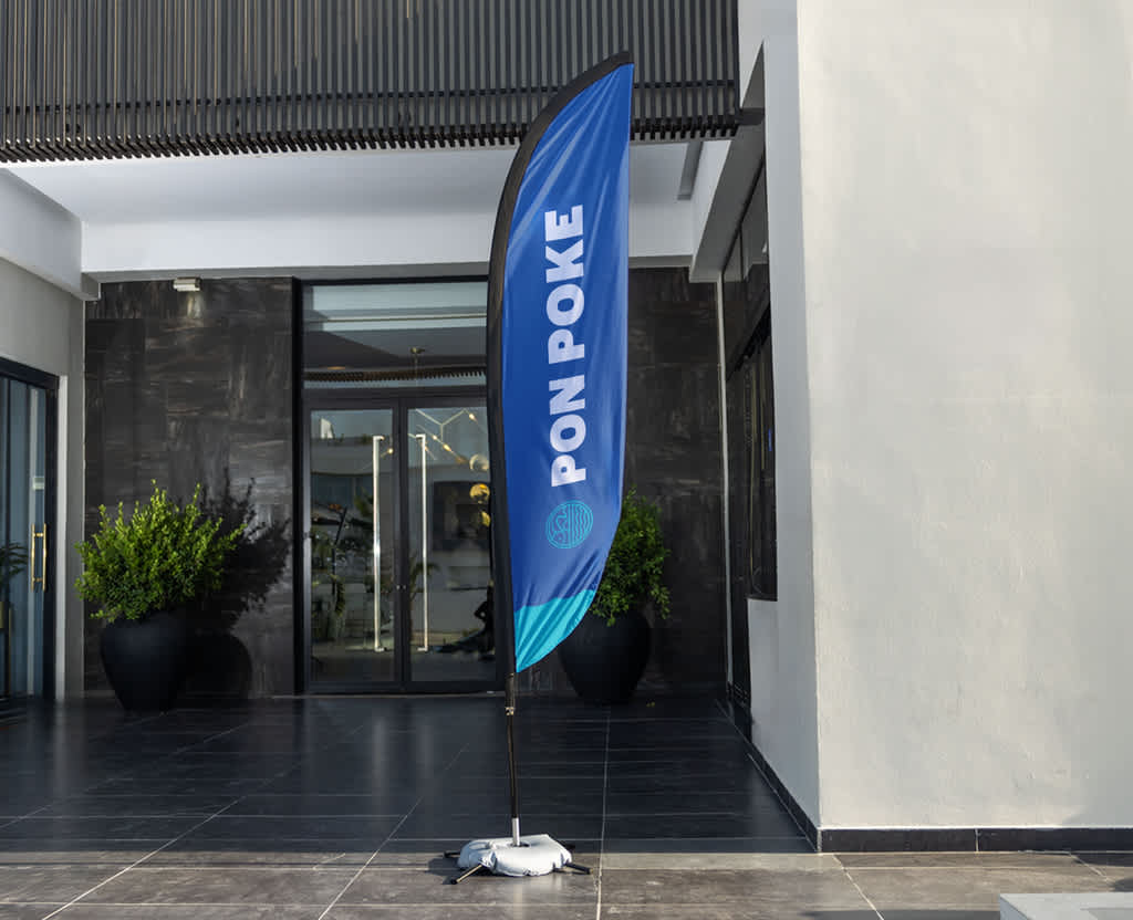 Poke shop feather flag outside building