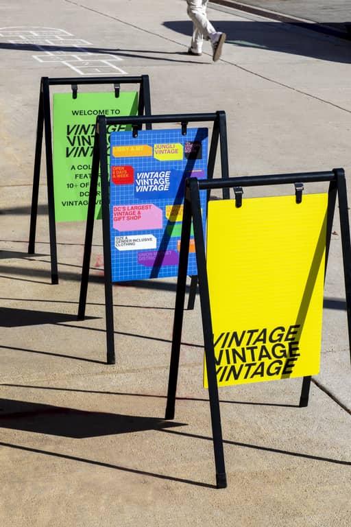 Three A-frame signs in the street for a vintage brand
