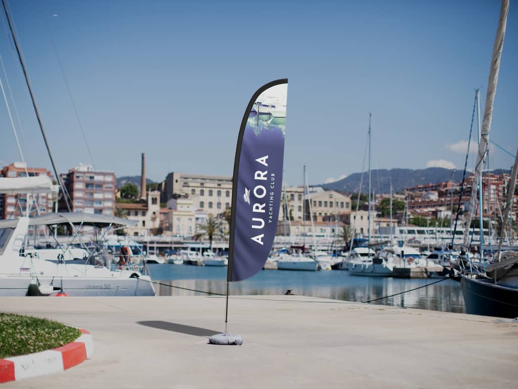 Yachting club flag with water base outside by a harbor