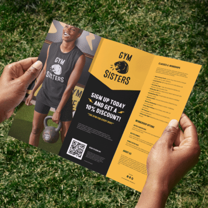 Tri-fold gym promotional flyer held outdoors, example layout showing bold headline typography and hierarchy for best fonts for flyers