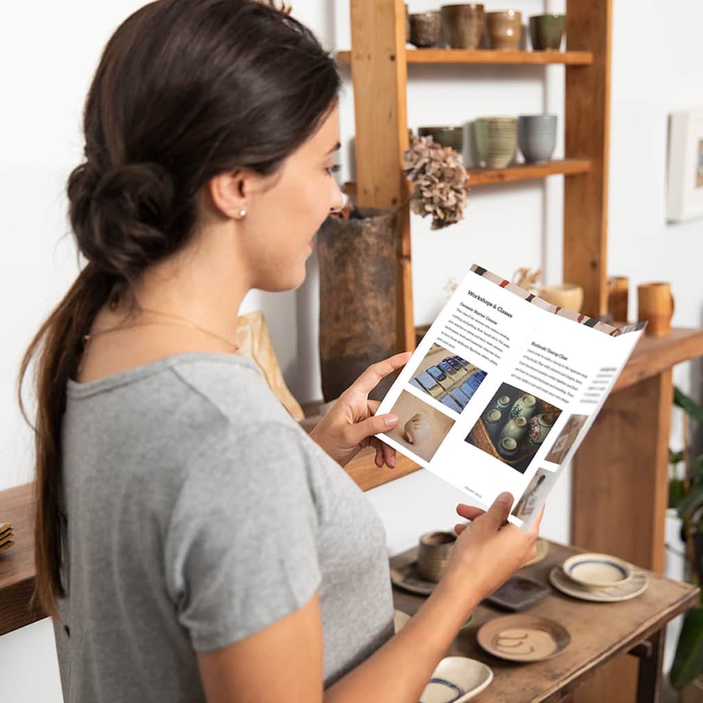 Customer reading a tri-fold business brochure