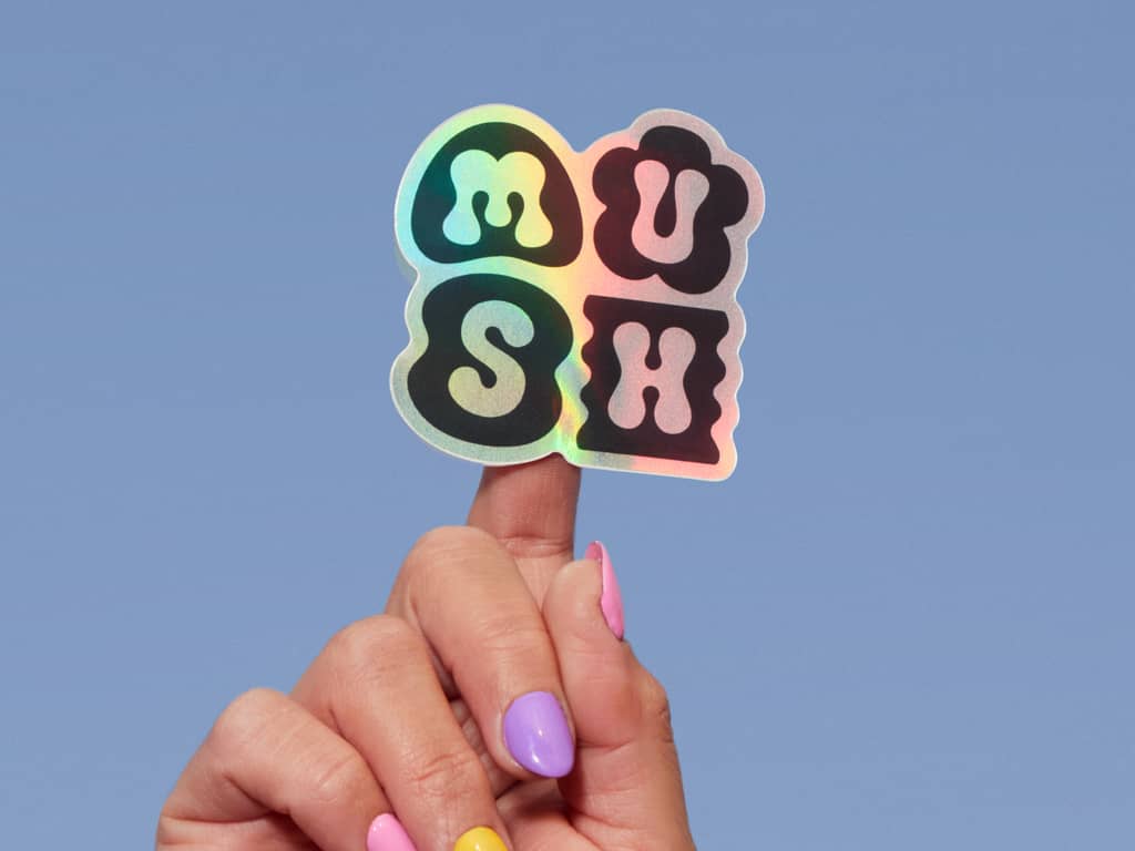 Hand holding up holographic business logo sticker