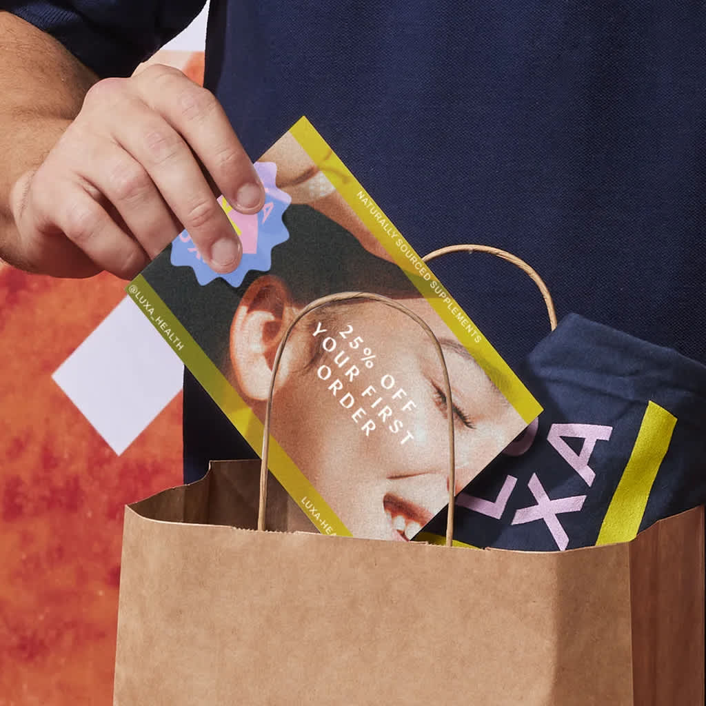 postcard for 25% off your first order being placed in paper bag