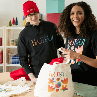 Custom branded beanie and apparel displayed in merch studio showing hat design ideas for small business branding