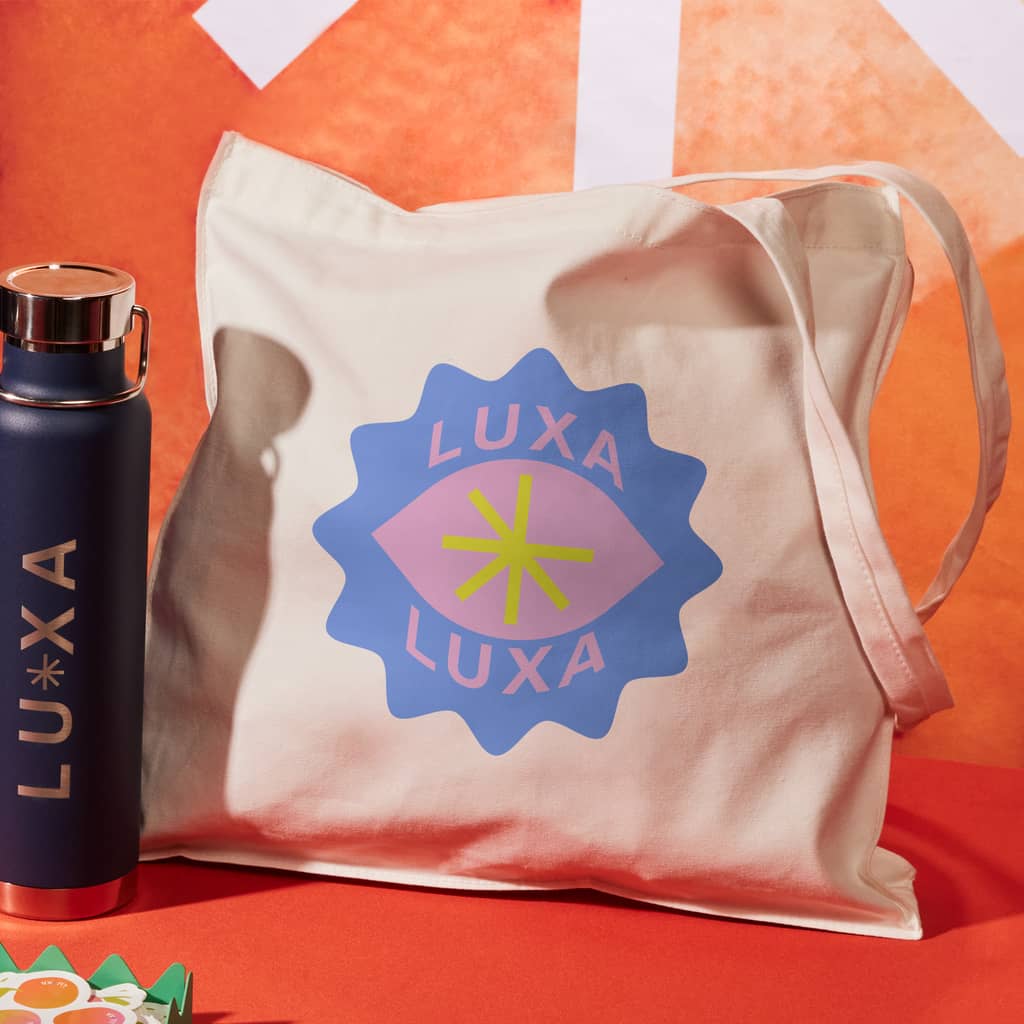 A branded canvas tote bag and water bottle