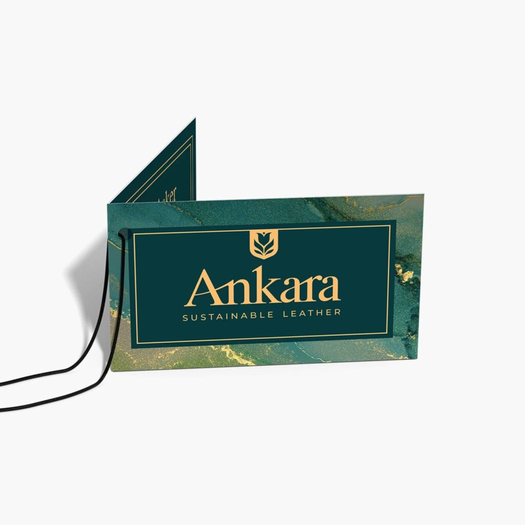 A dark teal and gold branded hand tag used to market a clothing line “Ankara”
