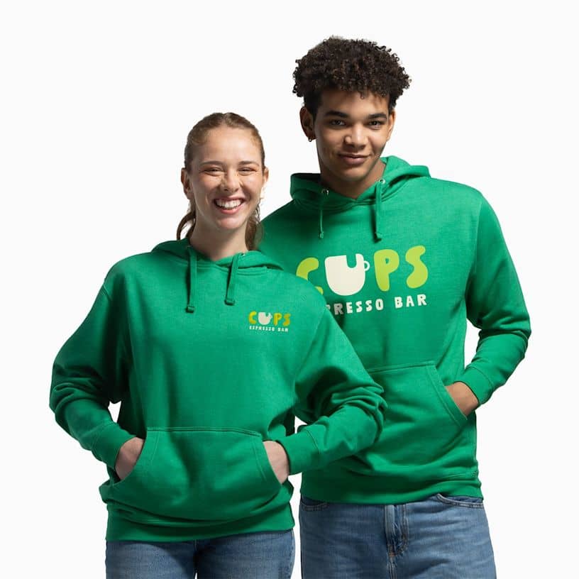 Two people wearing green branded pullover hoodies with different logo placements