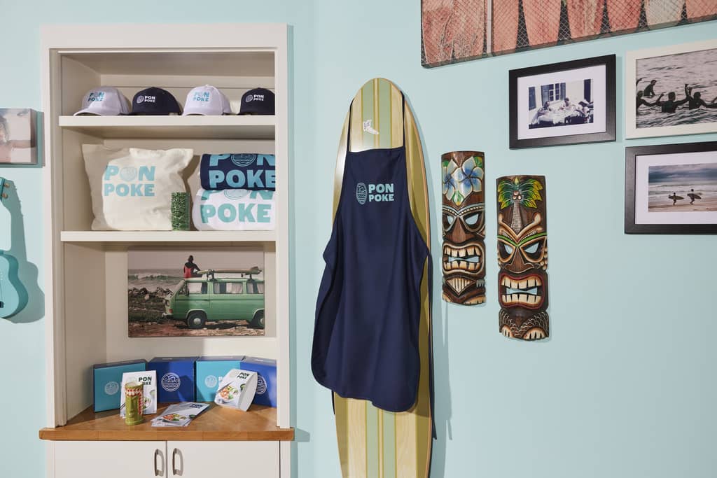 Branded promotional products – tote bags, caps, apron and more – presented at the store