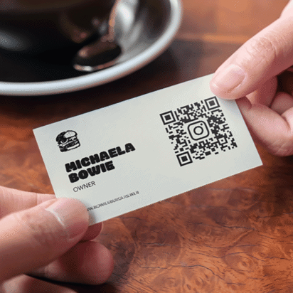 Event qr codes example on business card being handed over to capture leads and drive engagement