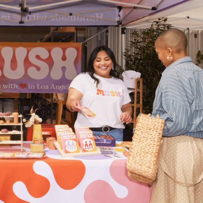 Small business events example with pop-up market booth engaging customers and selling handmade products