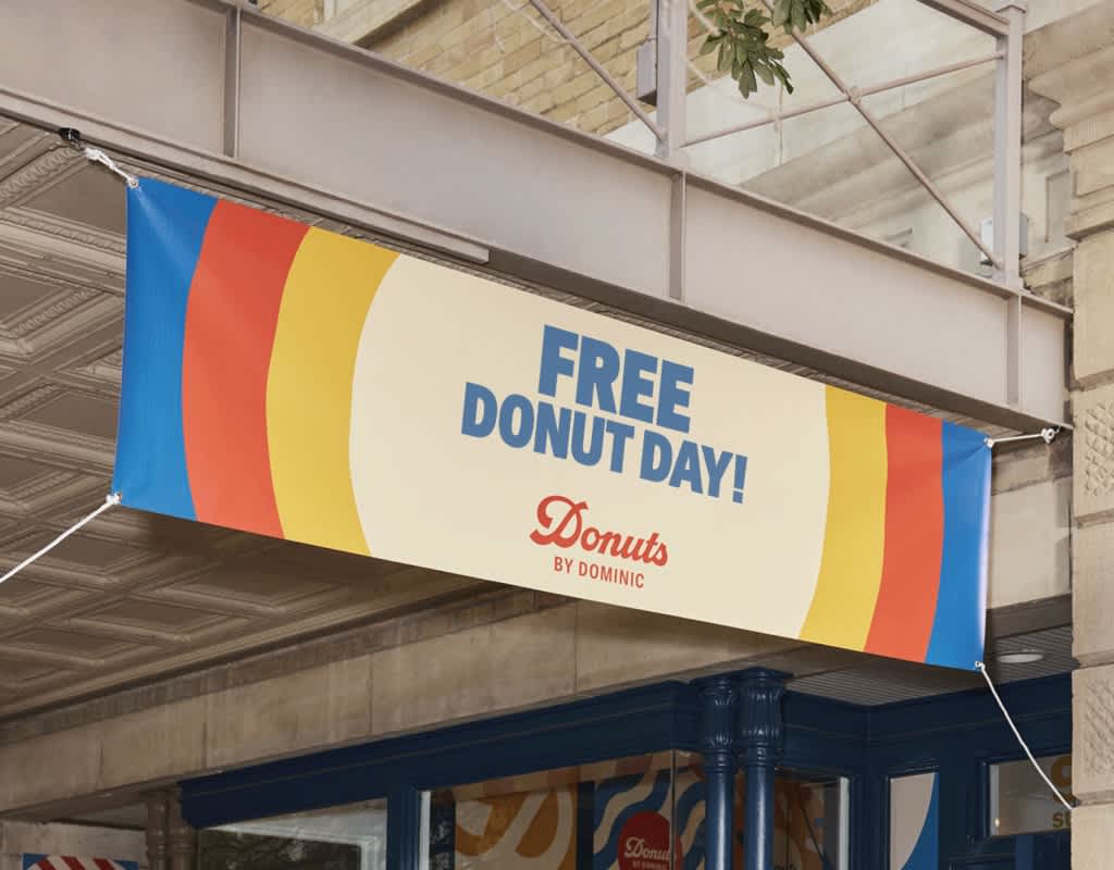 Large overhead banner promoting free donuts features retro-style primary colors