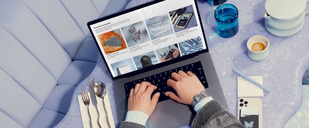 Someone looking through branded merch on laptop