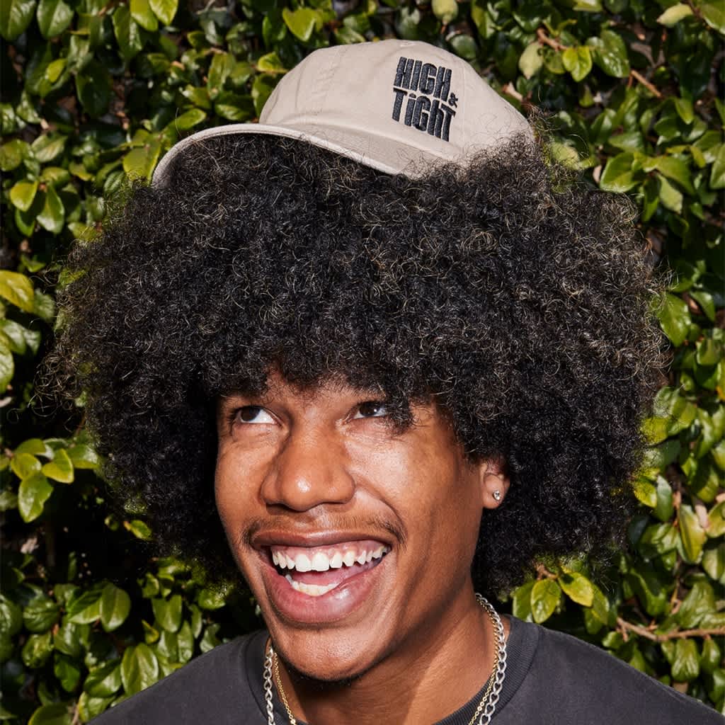 Man wearing a branded gray cap with simple embroidered black logo
