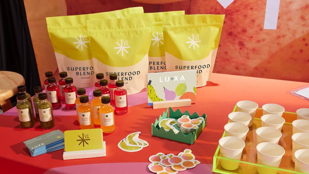 selection of branded products and marketing materials such as business cards and stickers on a colorful trade show booth