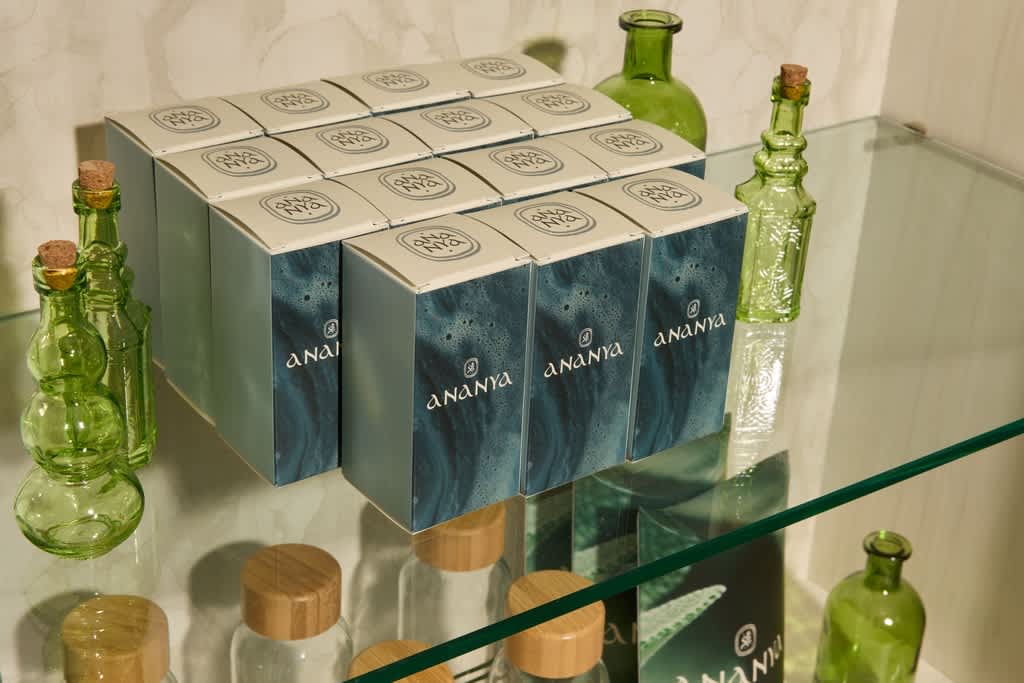 Green and white branded box packaging for a cosmetics brand