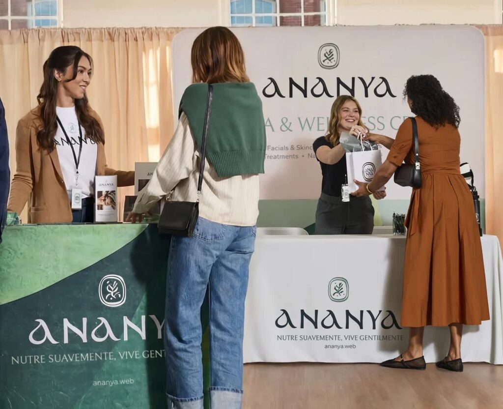 Trade show event marketing booth with Ananya branding, where staff interact with attendees, hand out branded bags and showcase products at a wellness-focused event