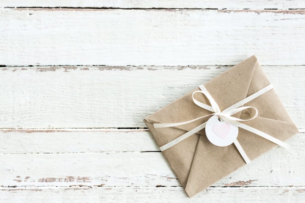 A card wrapped in ribbon with a heart