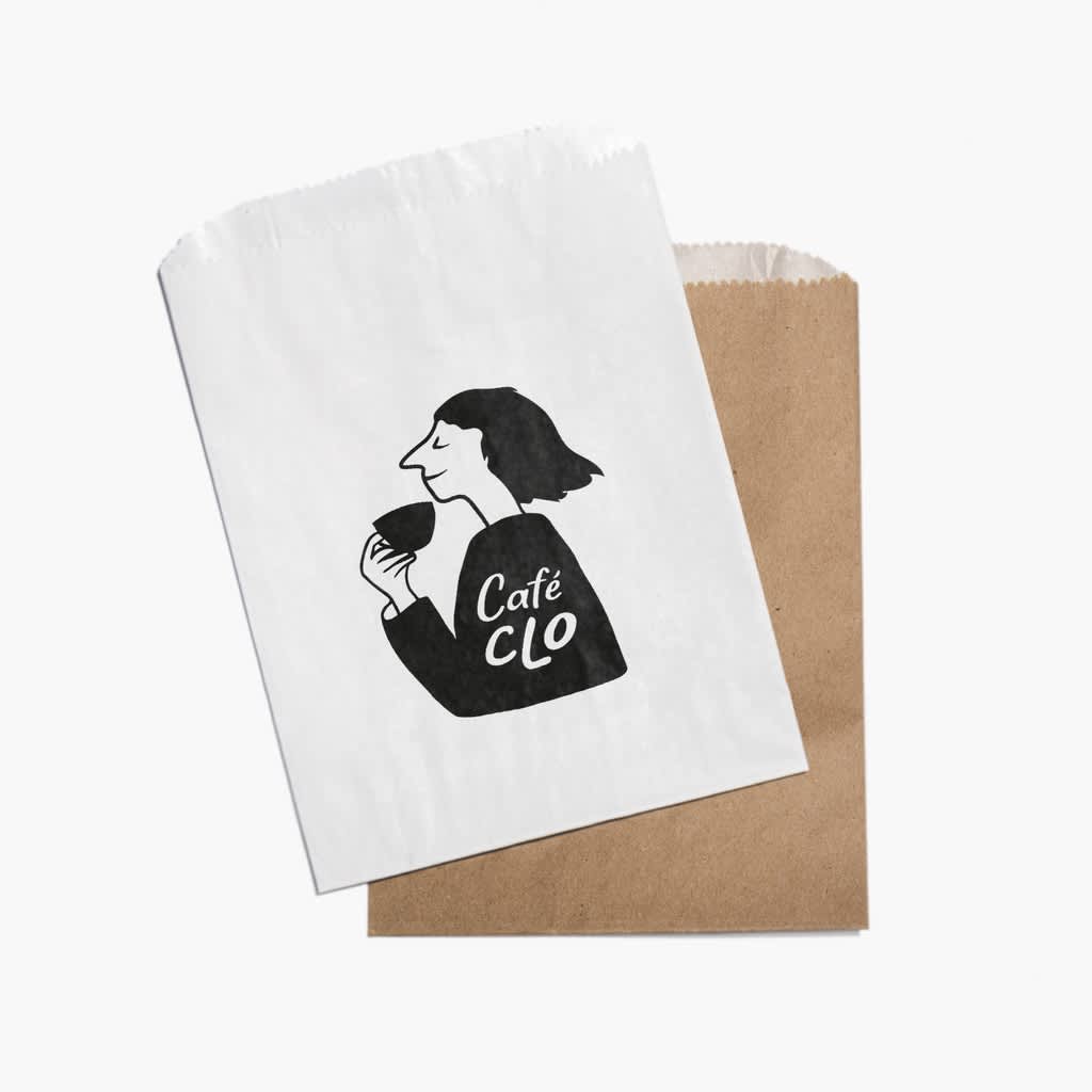 Eco friendly brown paper packaging for takeaway food and a white paper bag with an illustration of a woman drinking a cup of coffee.